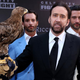 Here's Cage with a hawk (or maybe it's a falcon?) and some male models, just because. (Photo: Jonathan Leibson / Getty Images)